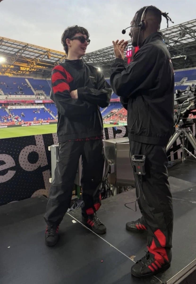 Charlie on a stadium stage during a soundcheck, headset on